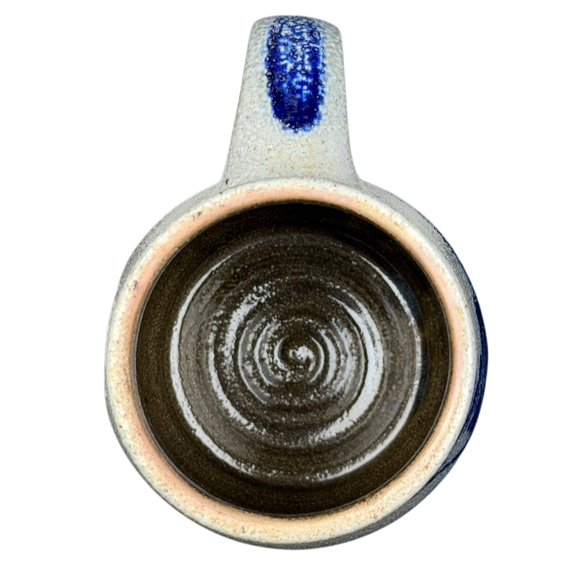 Inside view of Rowe Pottery Works blue bird mug showcasing its spiral design and unique glazing