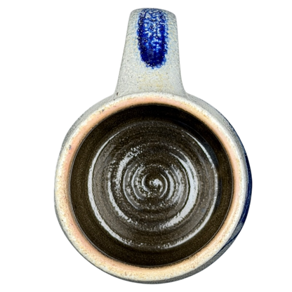 Inside view of Rowe Pottery Works blue bird mug showcasing its spiral design and unique glazing