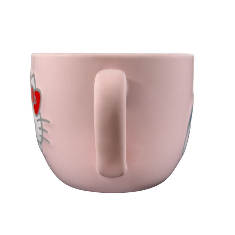 Side view of a pink Hello Kitty collectible Sanrio mug with a cute design
