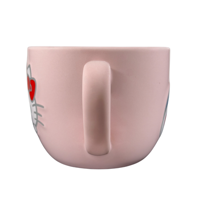 Side view of a pink Hello Kitty collectible Sanrio mug with a cute design