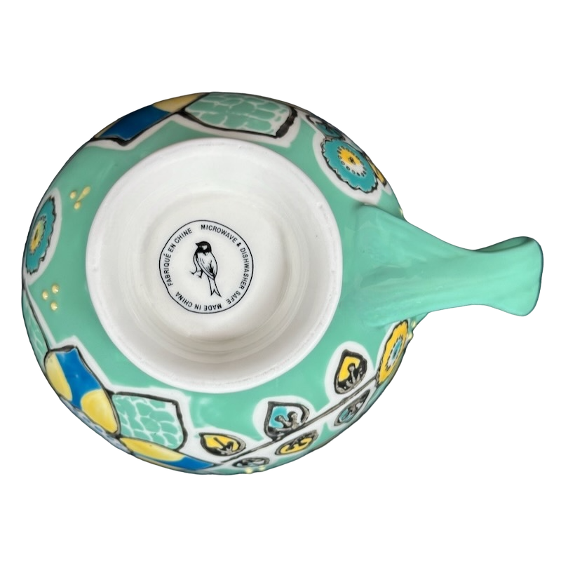 Top view of Anthropologie Elka Ayaka green floral pedestal mug showing mint green floral pattern and interior maker stamp