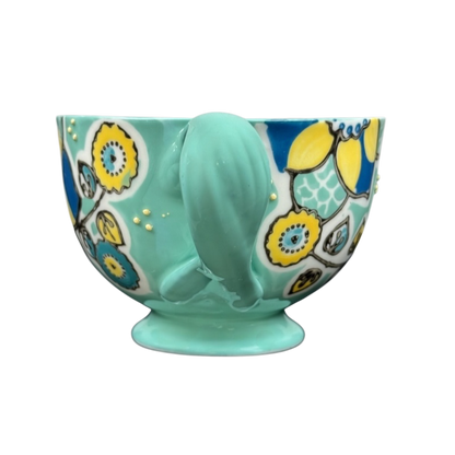 Anthropologie Elka Ayaka green floral pedestal mug ceramic turquoise mug with yellow blue floral pattern and gold dots