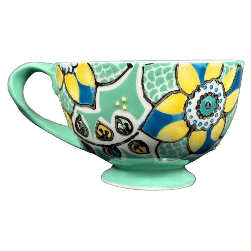 Anthropologie Elka Ayaka green floral pedestal mug with yellow and blue flower pattern on mint base