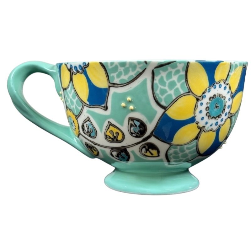 Anthropologie Elka Ayaka green floral pedestal mug with yellow blue flower pattern and gold dot accents