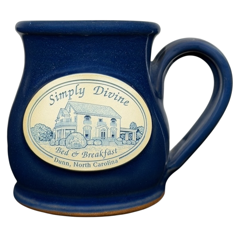 Simply Divine Bed and Breakfast Deneen mug featuring a scenic design in deep blue color