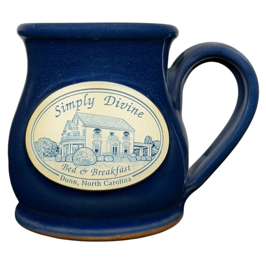 Simply Divine Bed and Breakfast Deneen mug featuring a scenic design in deep blue color