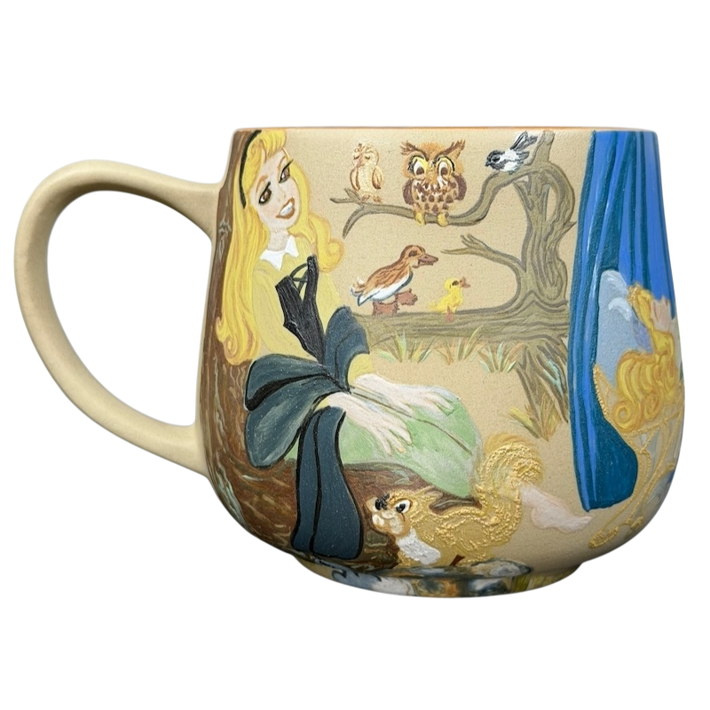 Sleeping Beauty hand-painted pottery mug featuring Aurora and woodland creatures in vibrant colors