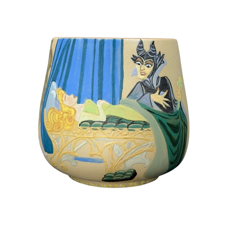 Sleeping Beauty hand-painted pottery mug featuring Maleficent and Aurora in a colorful design
