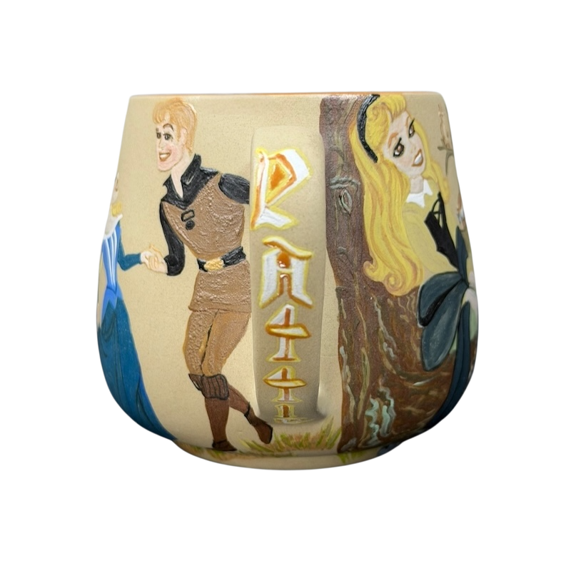 Sleeping Beauty hand-painted pottery mug featuring charming characters and vibrant artwork