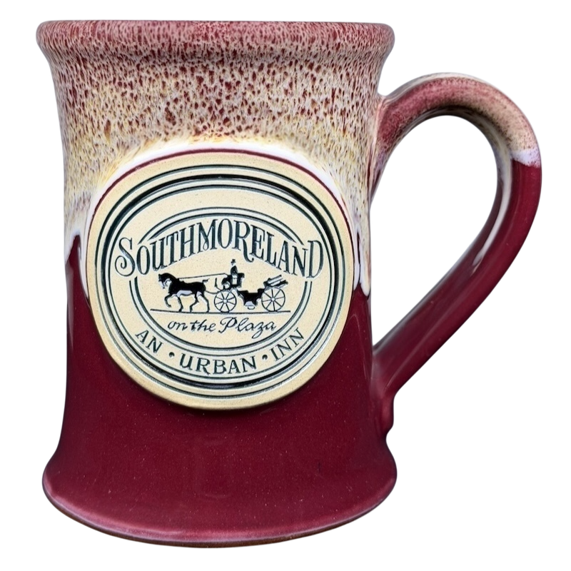 Southmoreland on the Plaza Deneen mug featuring a decorative logo and a red glaze finish