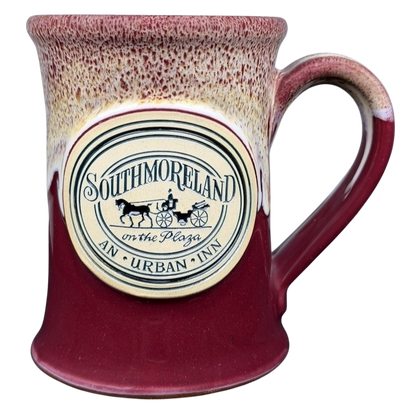 Southmoreland on the Plaza Deneen mug featuring a decorative logo and a red glaze finish