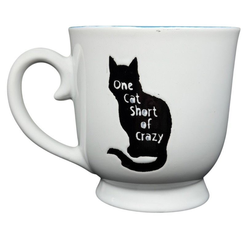 One Cat Short Of Crazy Mug by Spectrum Designz featuring a silhouette of a cat