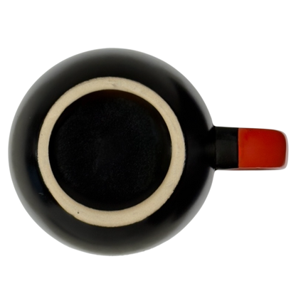 Top view of Spectrum Designz Day of the Dead cat mug black glaze with red handle on black background