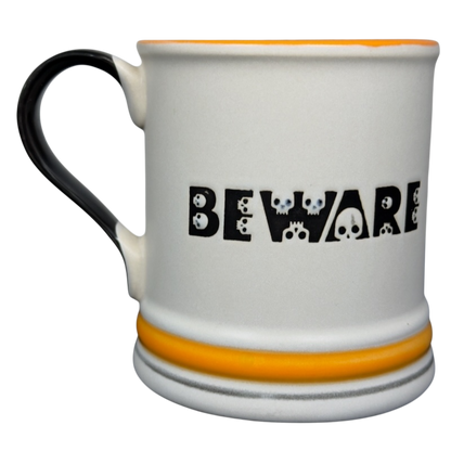Spectrum Designz Halloween skulls bat mug white ceramic mug with BEWARE skull lettering black handle orange rim and bands