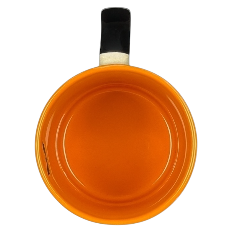 Top view of glossy orange ceramic mug with black handle on black background Spectrum Designz Halloween skulls bat mug