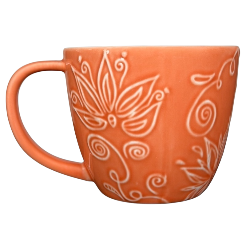 2006 Starbucks embossed coral flowers leaves mug featuring intricate floral designs in coral color