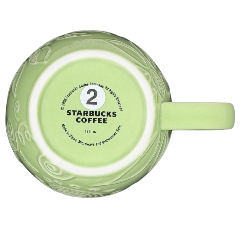 2006 Starbucks embossed green flowers hearts mug featuring a detailed design and 12 oz capacity
