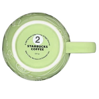 2006 Starbucks embossed green flowers hearts mug featuring a detailed design and 12 oz capacity