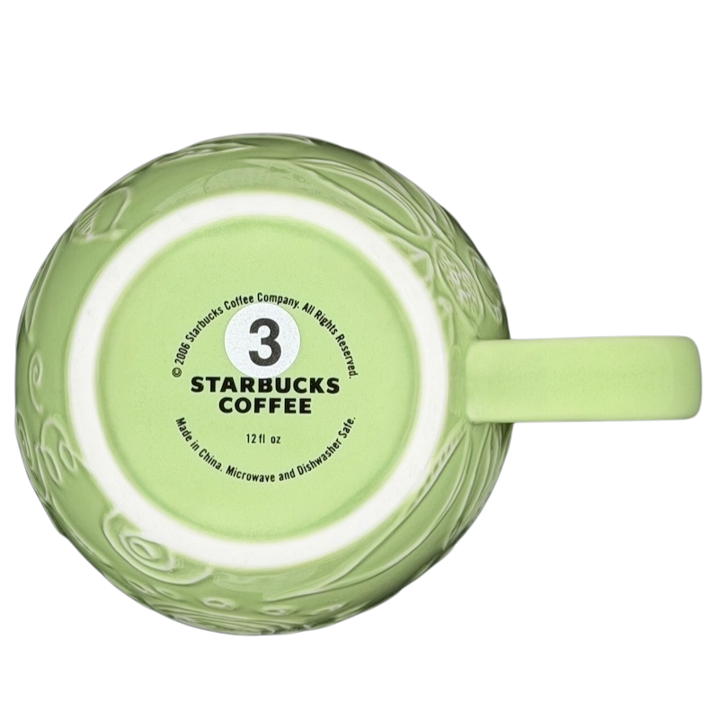 2006 Starbucks embossed green flowers hearts mug with a delicate design and 12 fl oz capacity