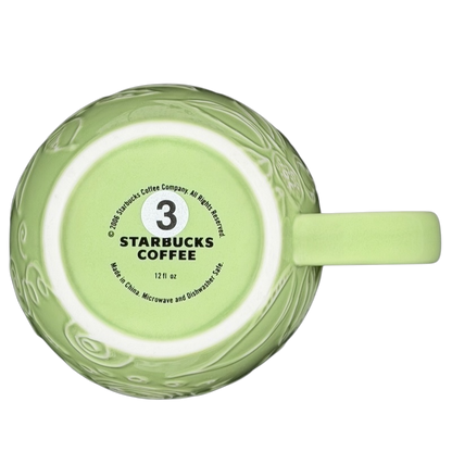 2006 Starbucks embossed green flowers hearts mug with a delicate design and 12 fl oz capacity