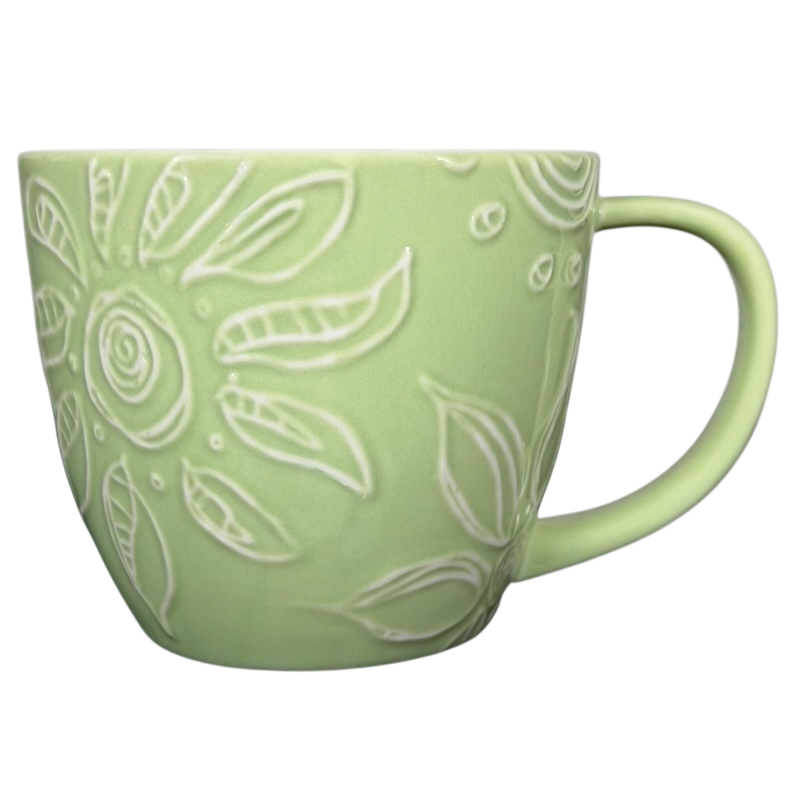 2006 Starbucks embossed green flowers hearts mug with intricate floral design and a comfortable handle