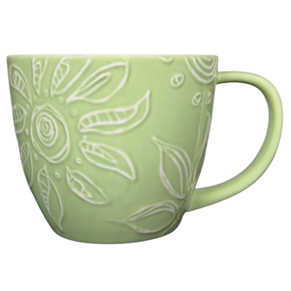 2006 Starbucks embossed green flowers hearts mug with intricate floral design and a comfortable handle