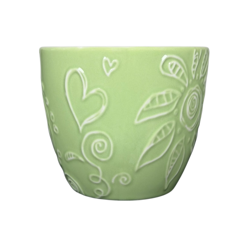 2006 Starbucks embossed green flowers hearts mug featuring intricate designs and a soft finish