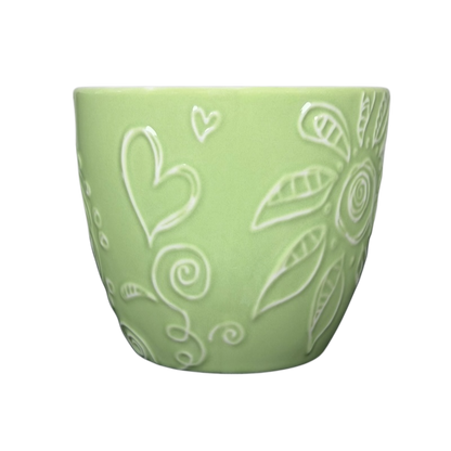 2006 Starbucks embossed green flowers hearts mug featuring intricate designs and a soft finish