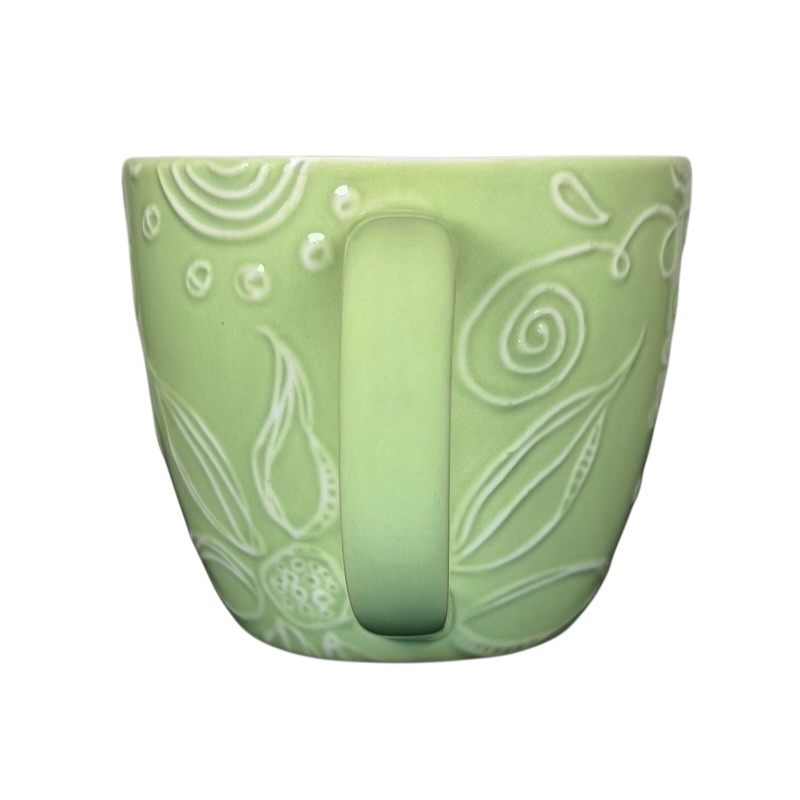 2006 Starbucks embossed green flowers hearts mug featuring intricate floral designs and a comfortable handle