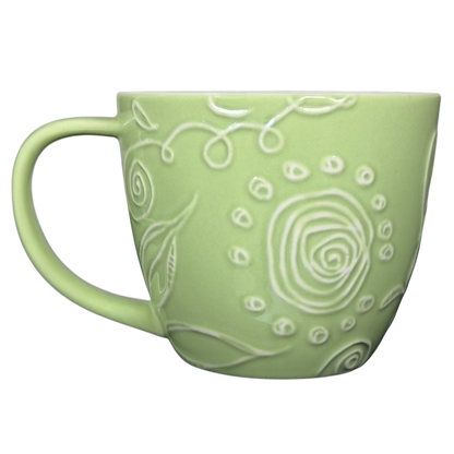 2006 Starbucks embossed green flowers hearts mug with intricate floral patterns