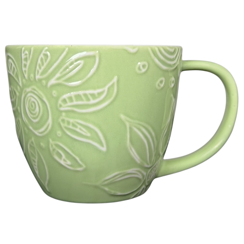 2006 Starbucks embossed green flowers hearts mug with intricate floral designs and a curved handle