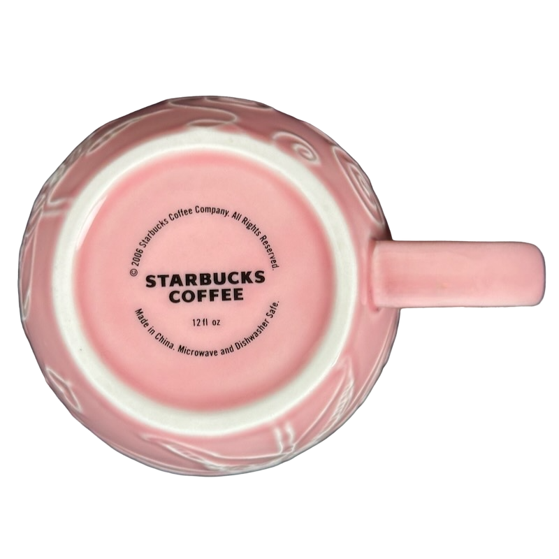 2006 Starbucks embossed pink flowers hearts mug featuring delicate floral designs and classic Starbucks logo