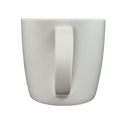 Back view of 2009 Starbucks vintage embossed siren logo mug. White ceramic with centered handle on black background