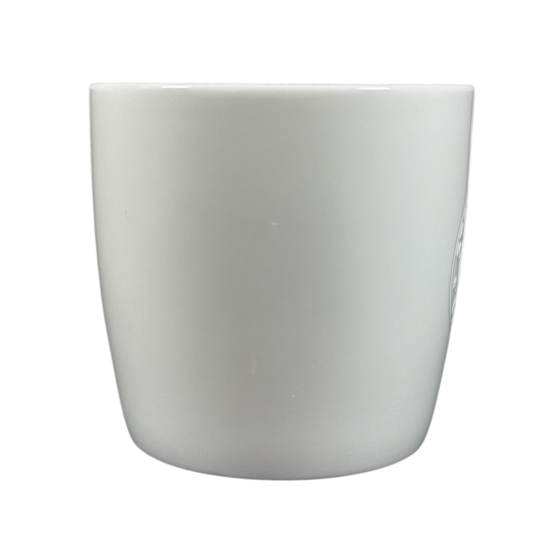 White ceramic 2009 Starbucks vintage embossed siren logo mug front view with subtle embossed siren detail