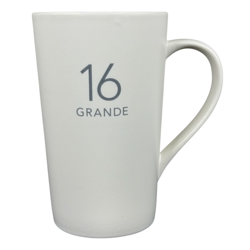 White tall ceramic 2011 vintage Starbucks 16 Grande mug with gray 16 GRANDE print and curved handle on right