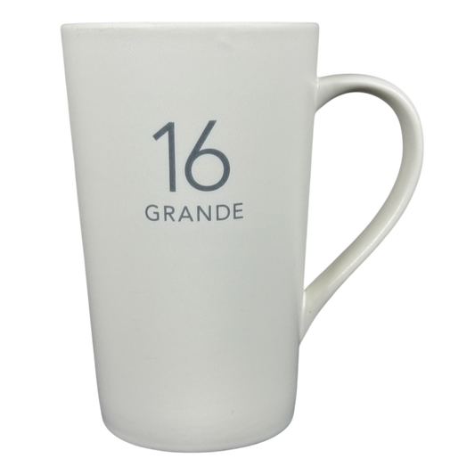 White tall ceramic 2011 vintage Starbucks 16 Grande mug with gray 16 GRANDE print and curved handle on right