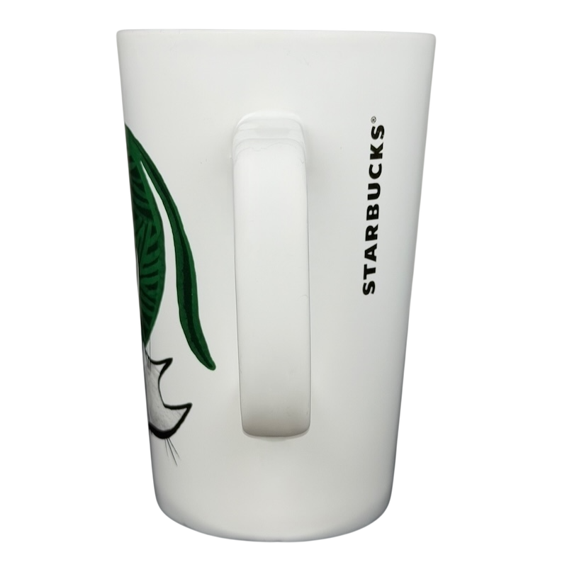 2015 Starbucks cat yarn collectible mug featuring a playful cat design on a white background