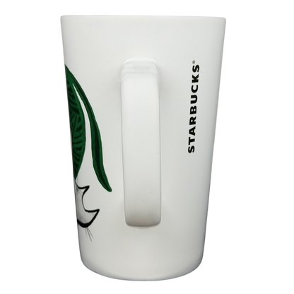 2015 Starbucks cat yarn collectible mug featuring a playful cat design on a white background