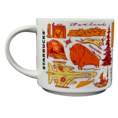 2018 Starbucks South Dakota Collectible mug featuring orange and red state-themed illustrations