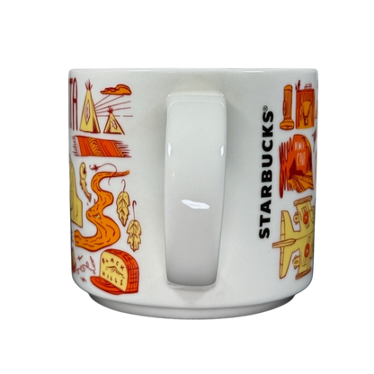 2018 Starbucks South Dakota Collectible mug with orange and yellow state-themed illustrations and Starbucks logo