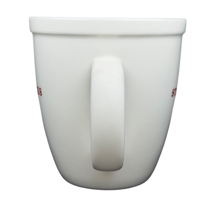 Starbucks Abbey 2007 red lettering holiday mug with a smooth white finish