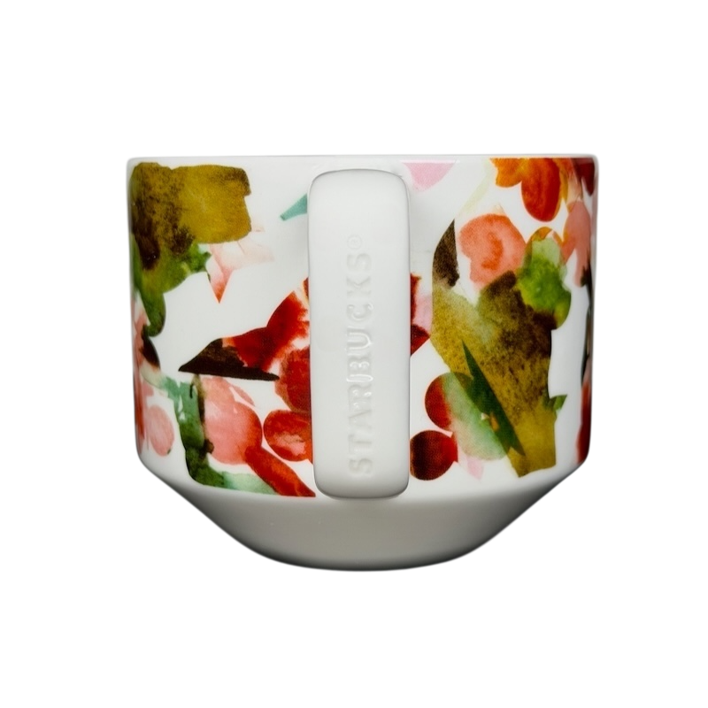 Starbucks Artisan Series collectible mug featuring a vibrant floral design in shades of green and pink