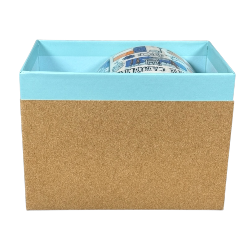 Starbucks Been There North Carolina mug partially visible inside a blue and brown gift box