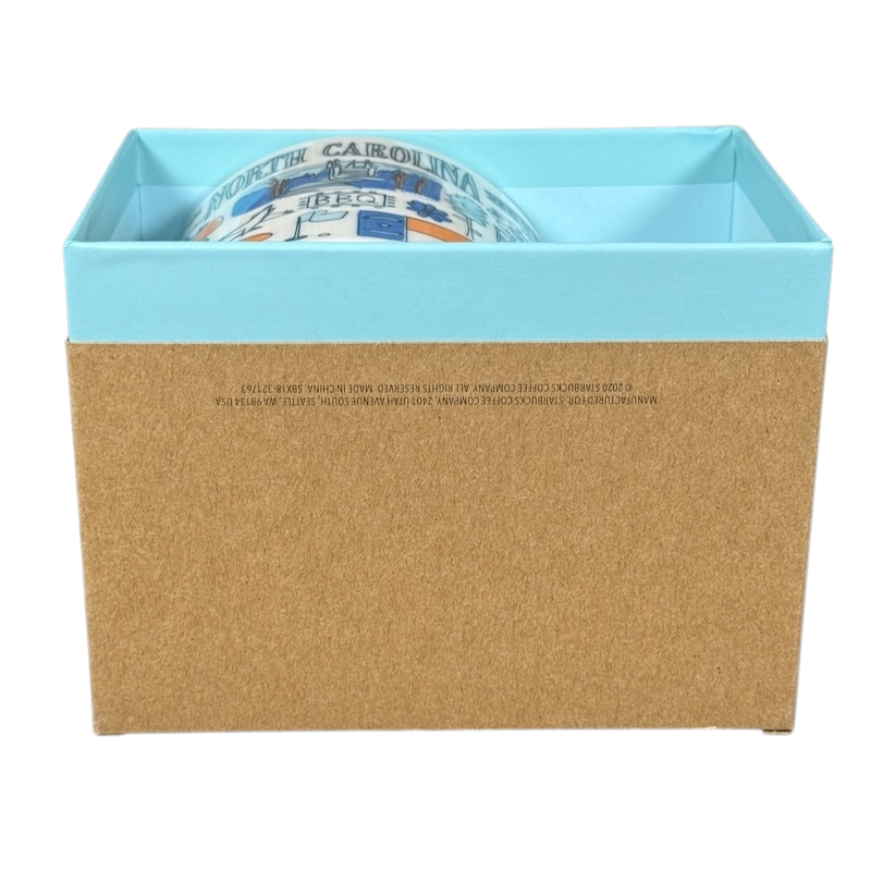 Starbucks Been There North Carolina mug partially visible inside blue and brown gift box
