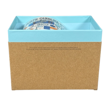 Starbucks Been There North Carolina mug partially visible inside blue and brown gift box