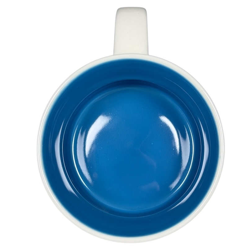 Top view of Starbucks Been There Series Maine mug with blue interior and white handle on black background