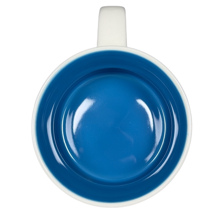 Top view of Starbucks Been There Series Maine mug with blue interior and white handle on black background