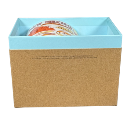Collectible Starbucks mug New Mexico partially visible inside a blue and brown gift box on black background
