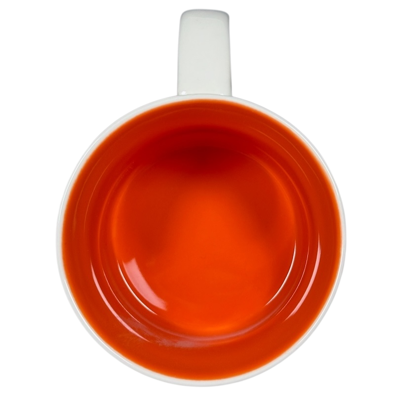 Top view of collectible Starbucks mug New Mexico with vibrant orange interior and white handle
