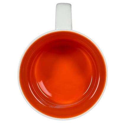 Top view of collectible Starbucks mug New Mexico with vibrant orange interior and white handle